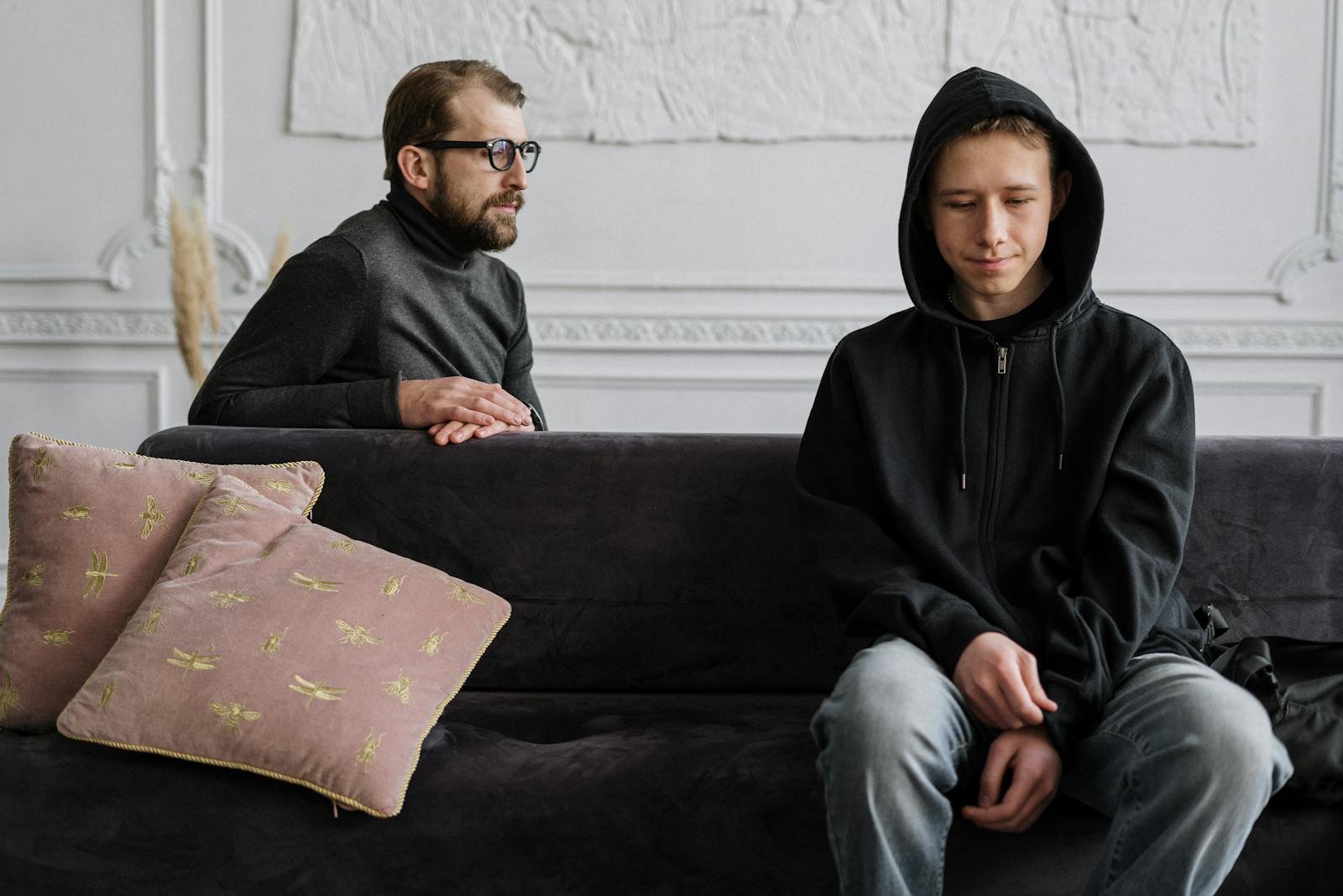 Man in Black Hoodie Sitting on Brown Couch taking teen therapy